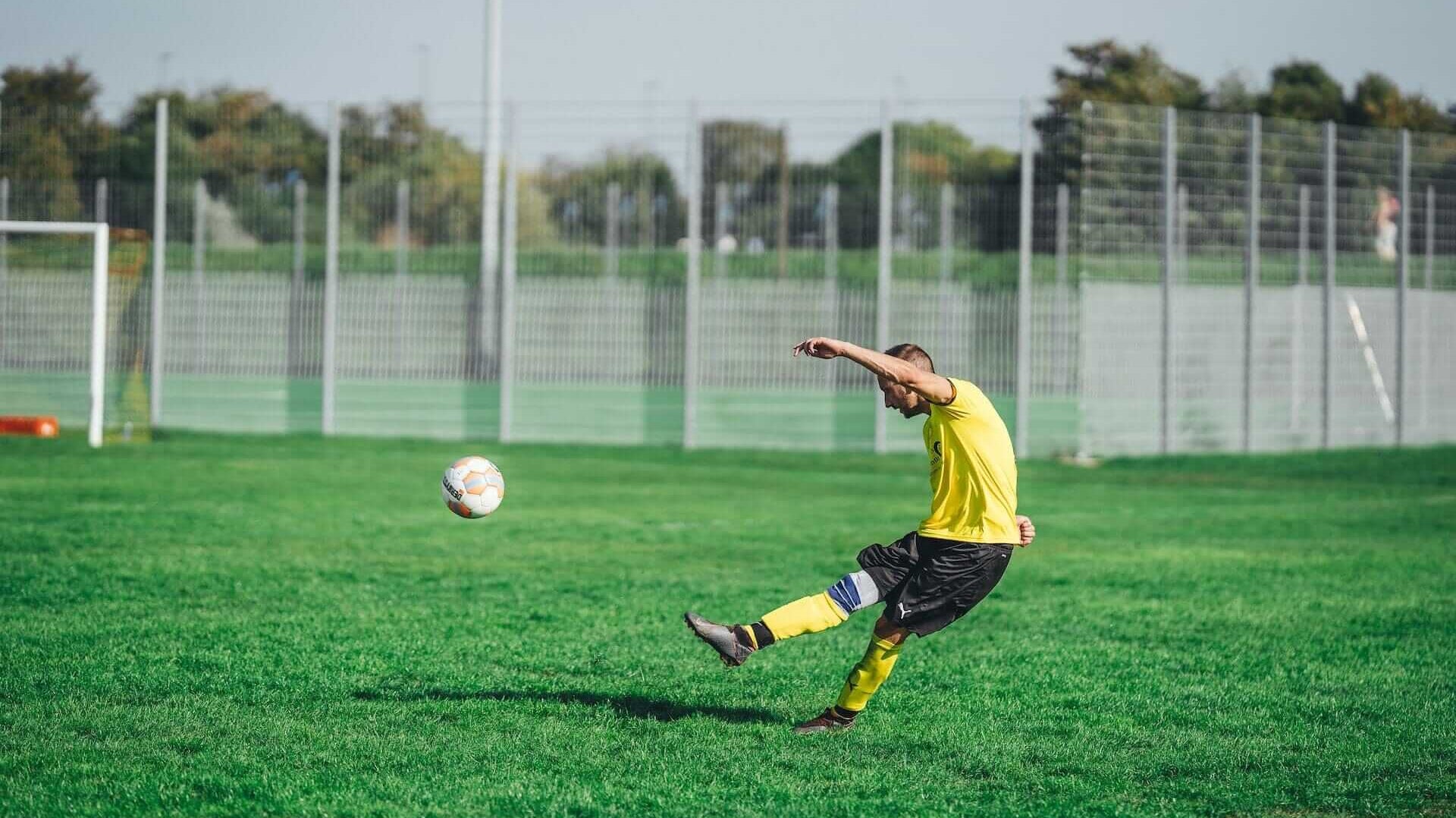 guy kicking a soccer ball