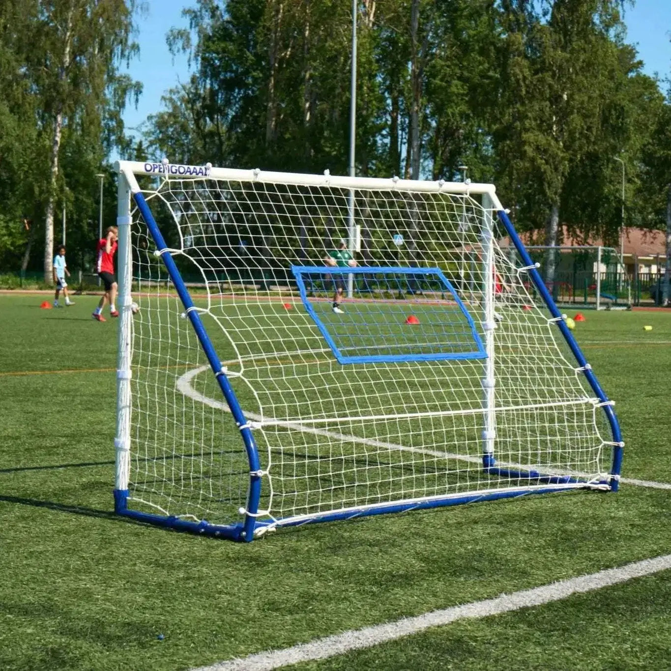 3-in-1 soccer goal rebounder trainer with adjustable net for shooting, passing, and ball control practice on grass field