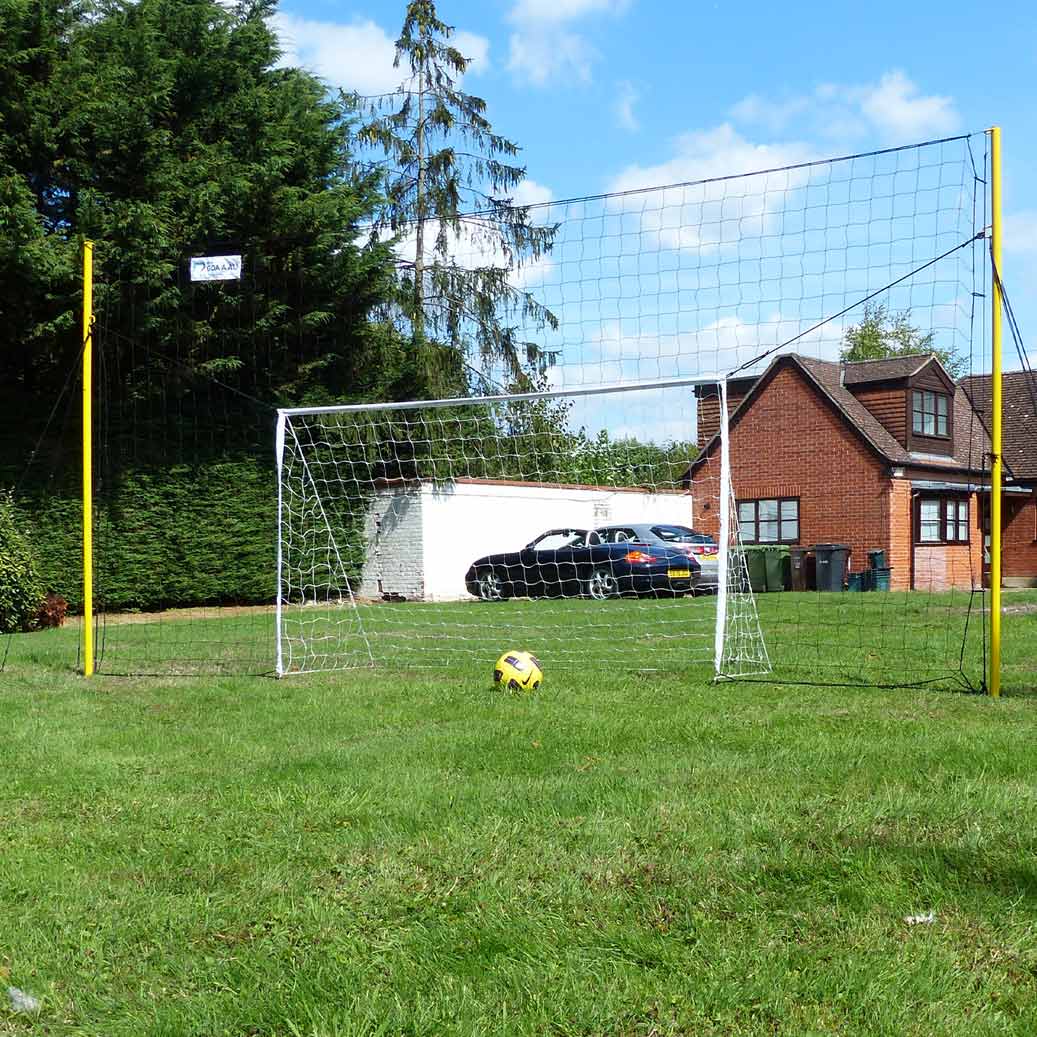 Junior 3-in-1 soccer goal trainer with rebounder and backstop in backyard