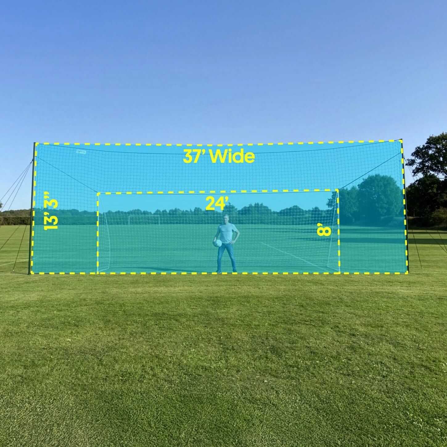 Large green net with measurements on a grassy field under a clear blue sky.