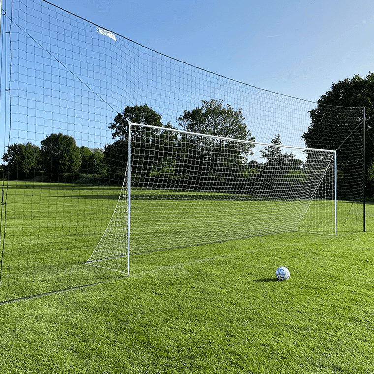 full size 3-in-1 soccer goal trainer with rebounder and backstop on grass field