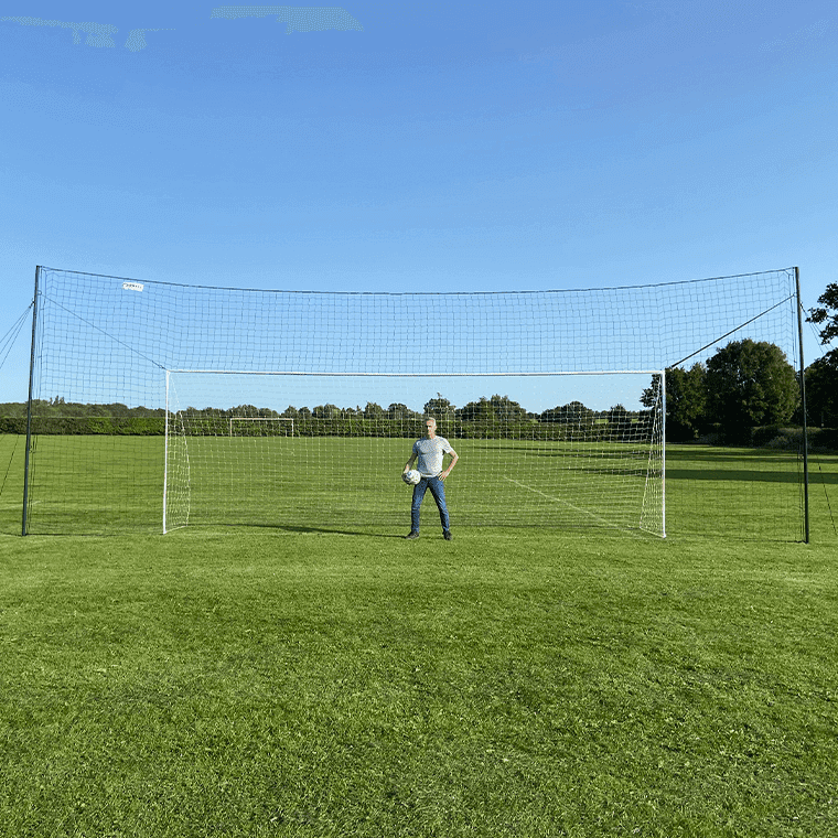 3-in-1 soccer goal trainer full size with rebounder and backstop on grass field