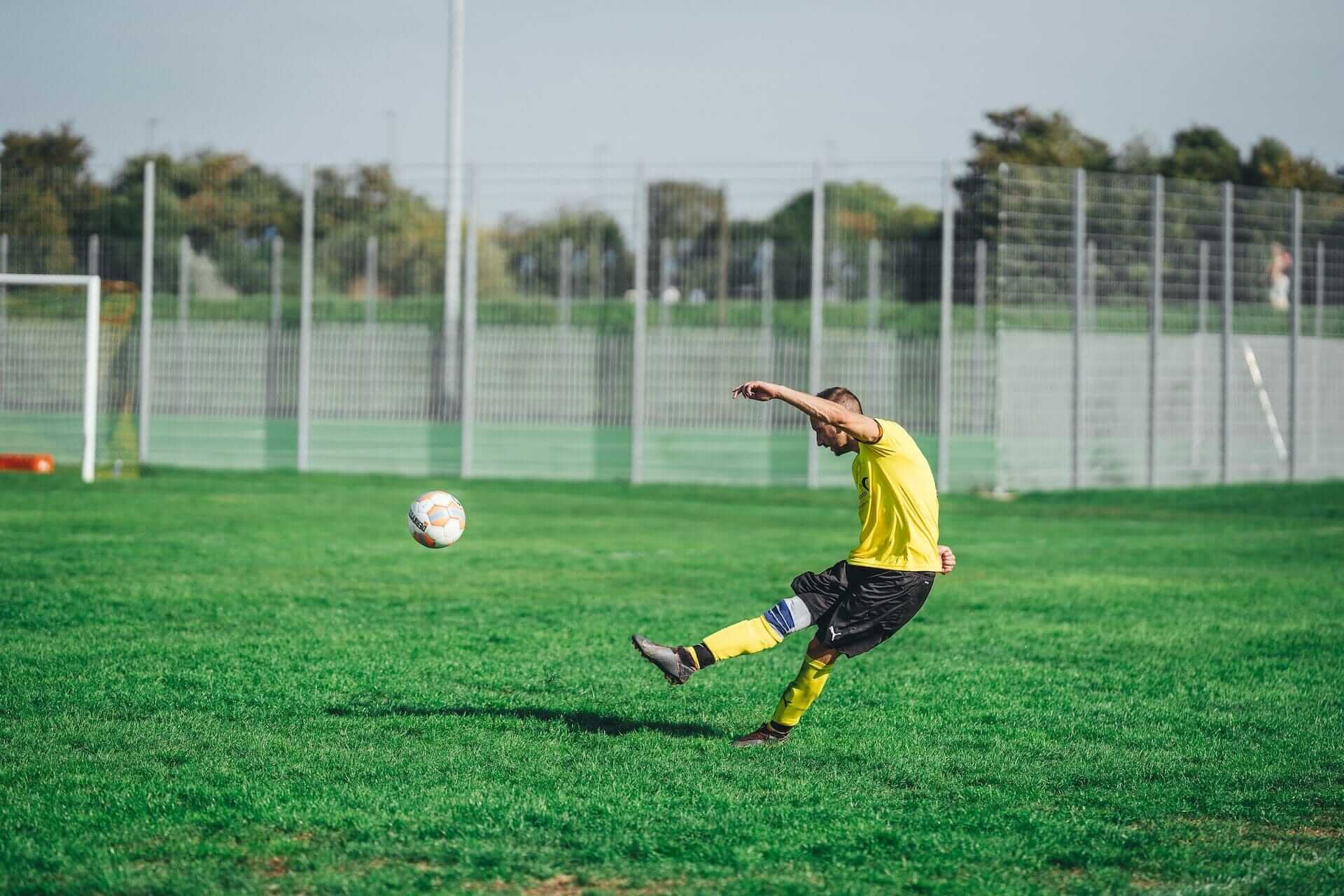 guy kicking a soccer ball