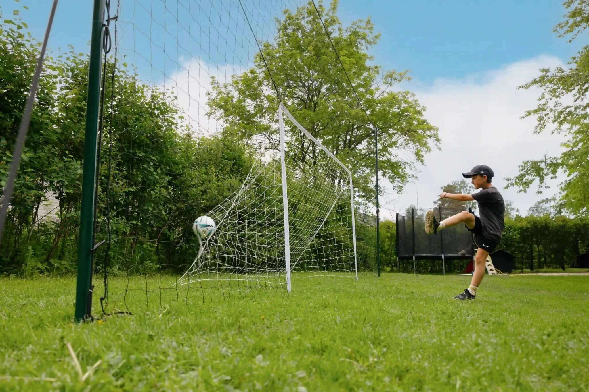Backyard soccer goal with rebounder and backstop for kids.