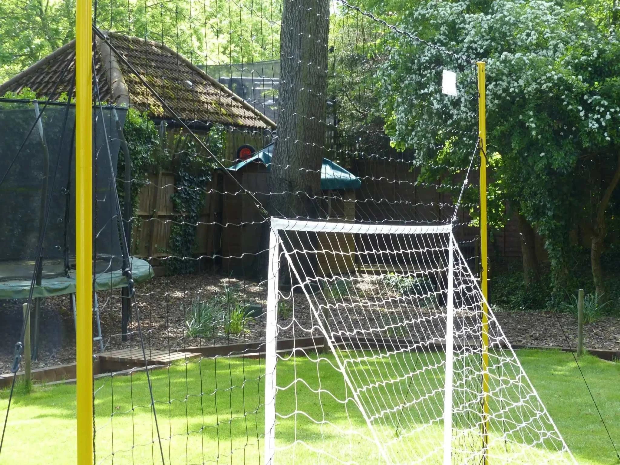 Open Goaaal® Soccer 3-in-1 Trainer with net in backyard setup.