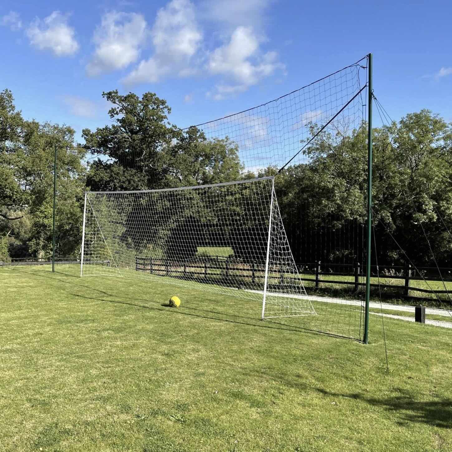 3-in-1 soccer goal trainer set up in backyard for kids' practice